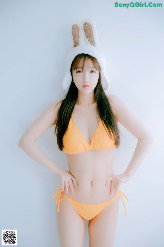 A woman in a bikini with bunny ears on her head.