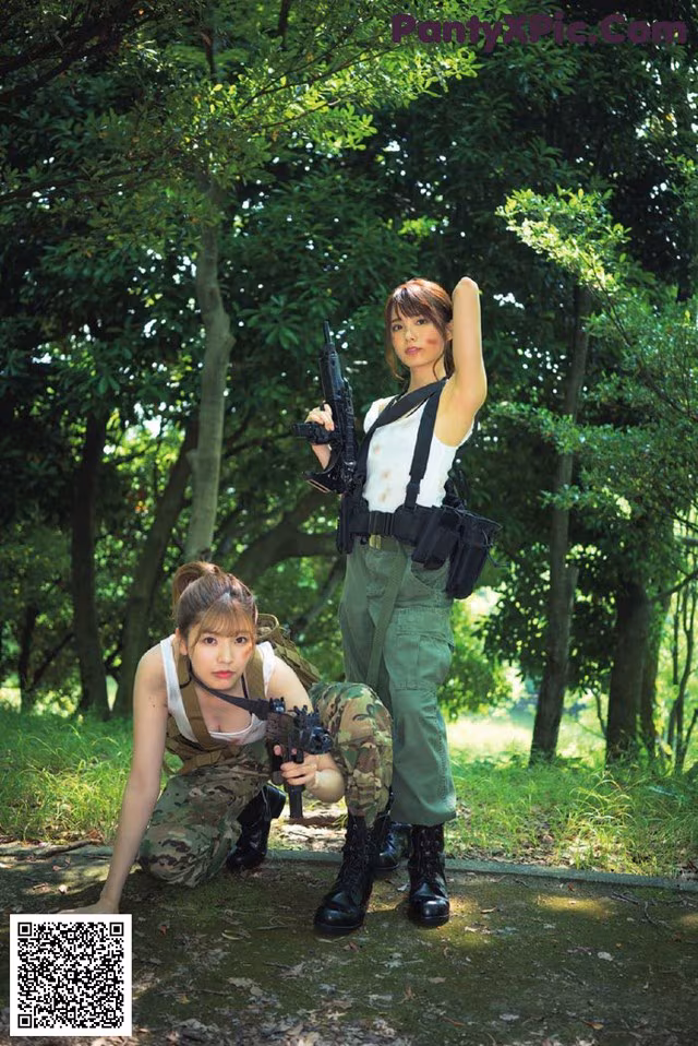 A couple of women in military uniforms posing for a picture.