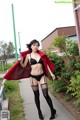 A woman in lingerie and stockings posing for a picture.