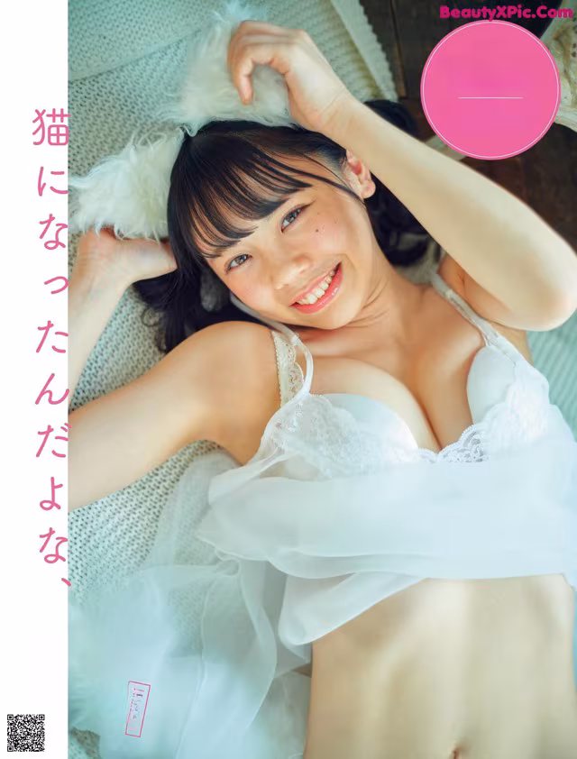 A woman in a white lingerie laying on a bed.