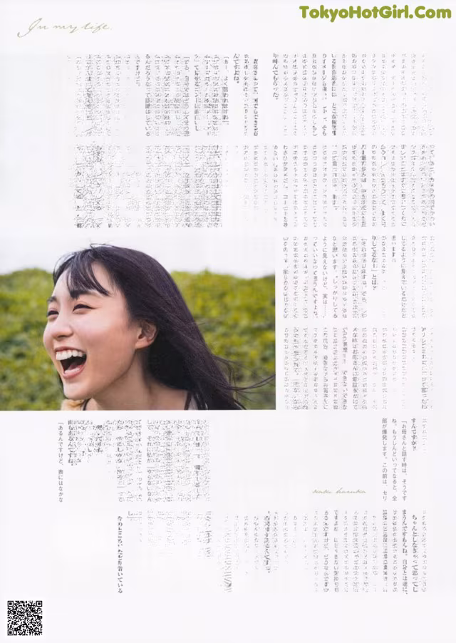 A magazine page with a picture of a woman laughing.
