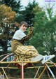 A woman sitting on top of a metal structure.