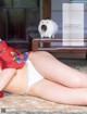 A woman in a red and white bikini laying on the floor.