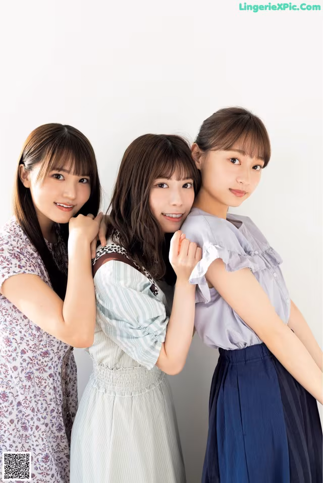 A group of three young women standing next to each other.